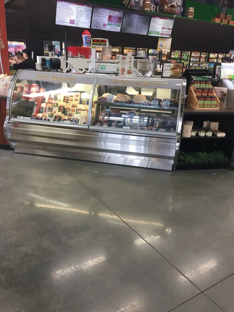 Regal Marketplace deli counter with fresh meats, cheeses and the sandwich menu board